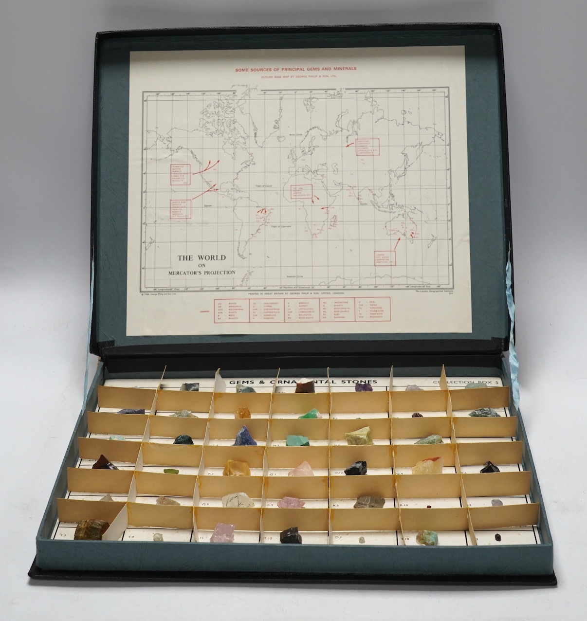 A case of uncut gems and ornamental stones, including diamond, amethyst, nephrite, malachite, rutilated quartz, etc. Fair condition.